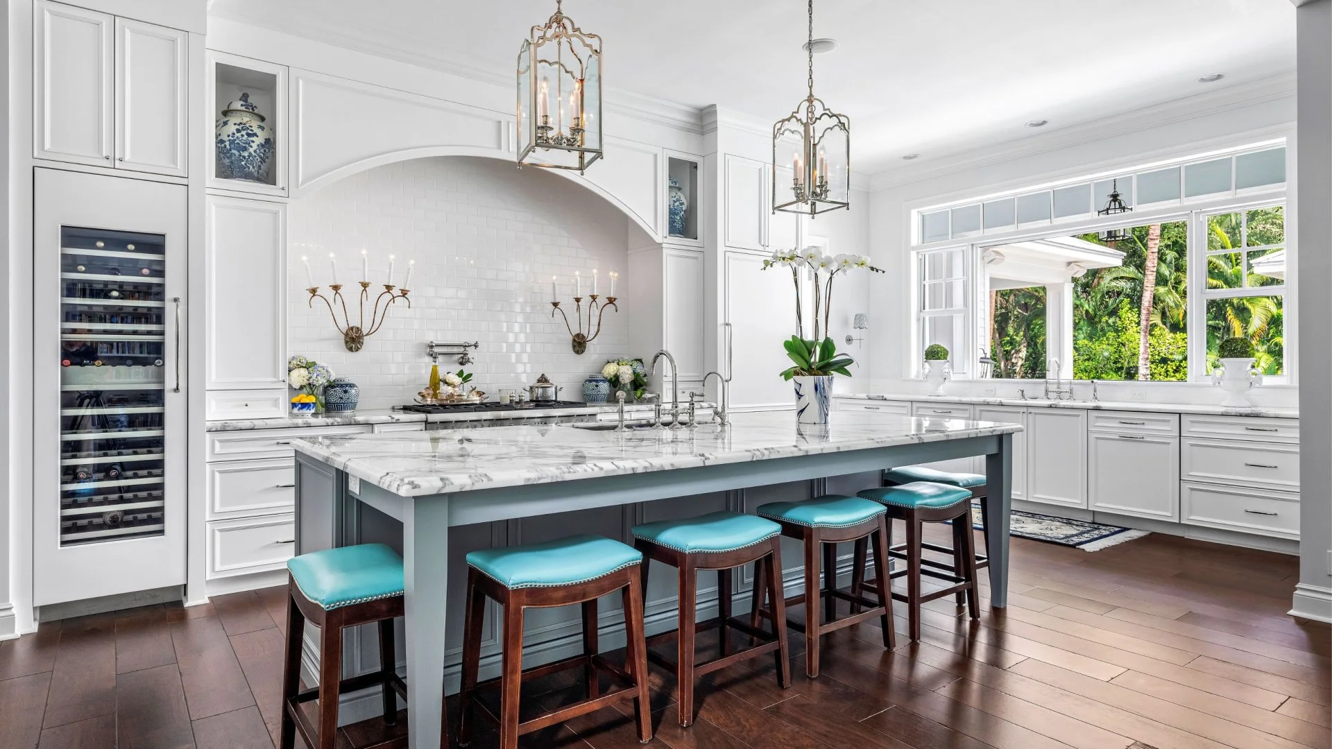 Contemporary Manhattan Kitchen Design Modern kitchen with marble island and blue stools in Manhattan.
