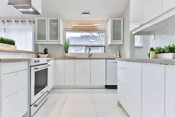 Modern kitchen with white cabinets and stainless steel appliances in Manhattan.